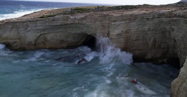The remains of a sailboat are seen in the water after it smashed into rocks and sank off the island of Kythira, southern Greece, Oct. 6, 2022. (AP Photo)