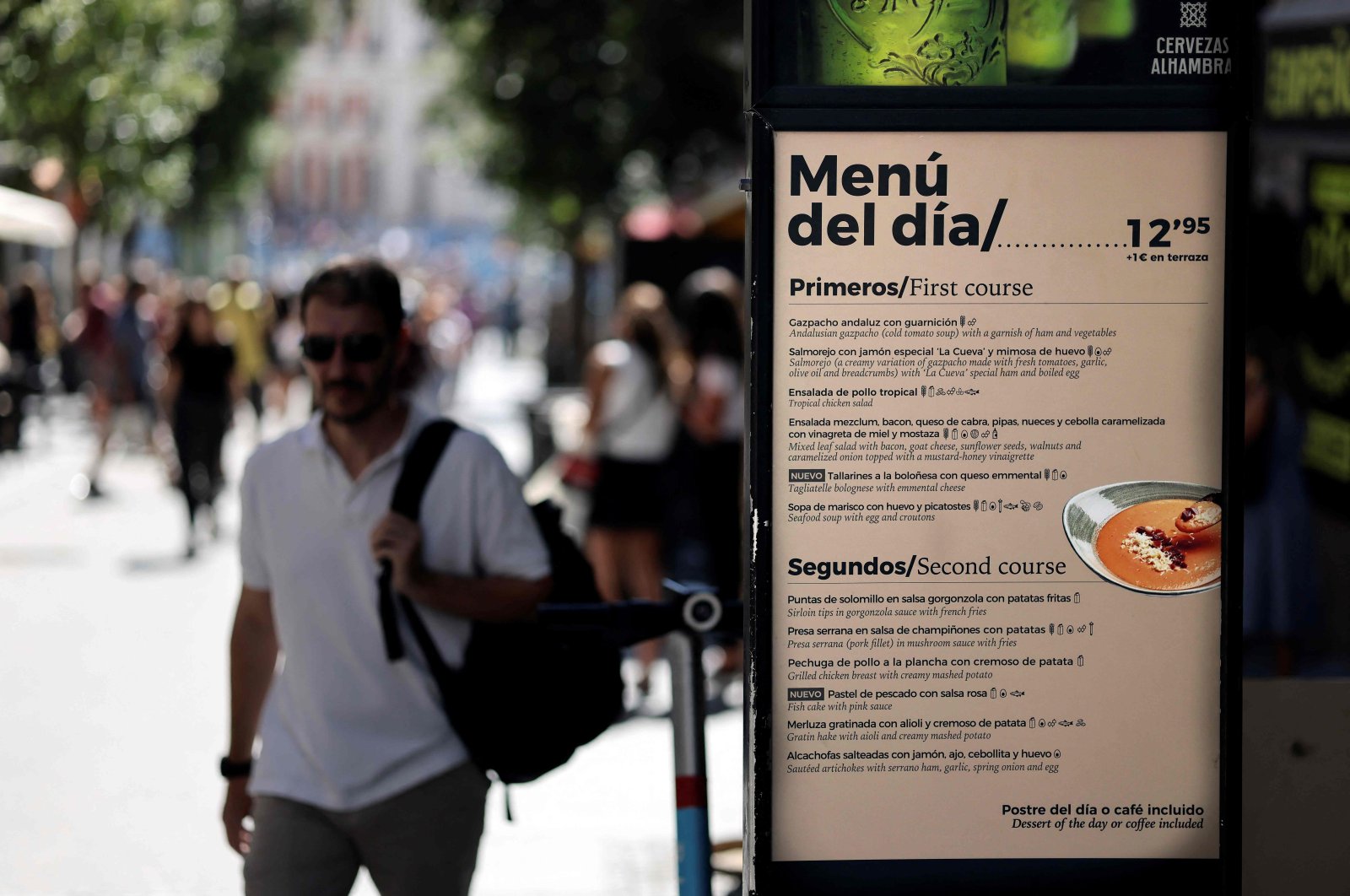 A pedestrian walks past a board showing today&#039;s menu in Madrid, Spain, Sept. 5, 2022. (AFP Photo)