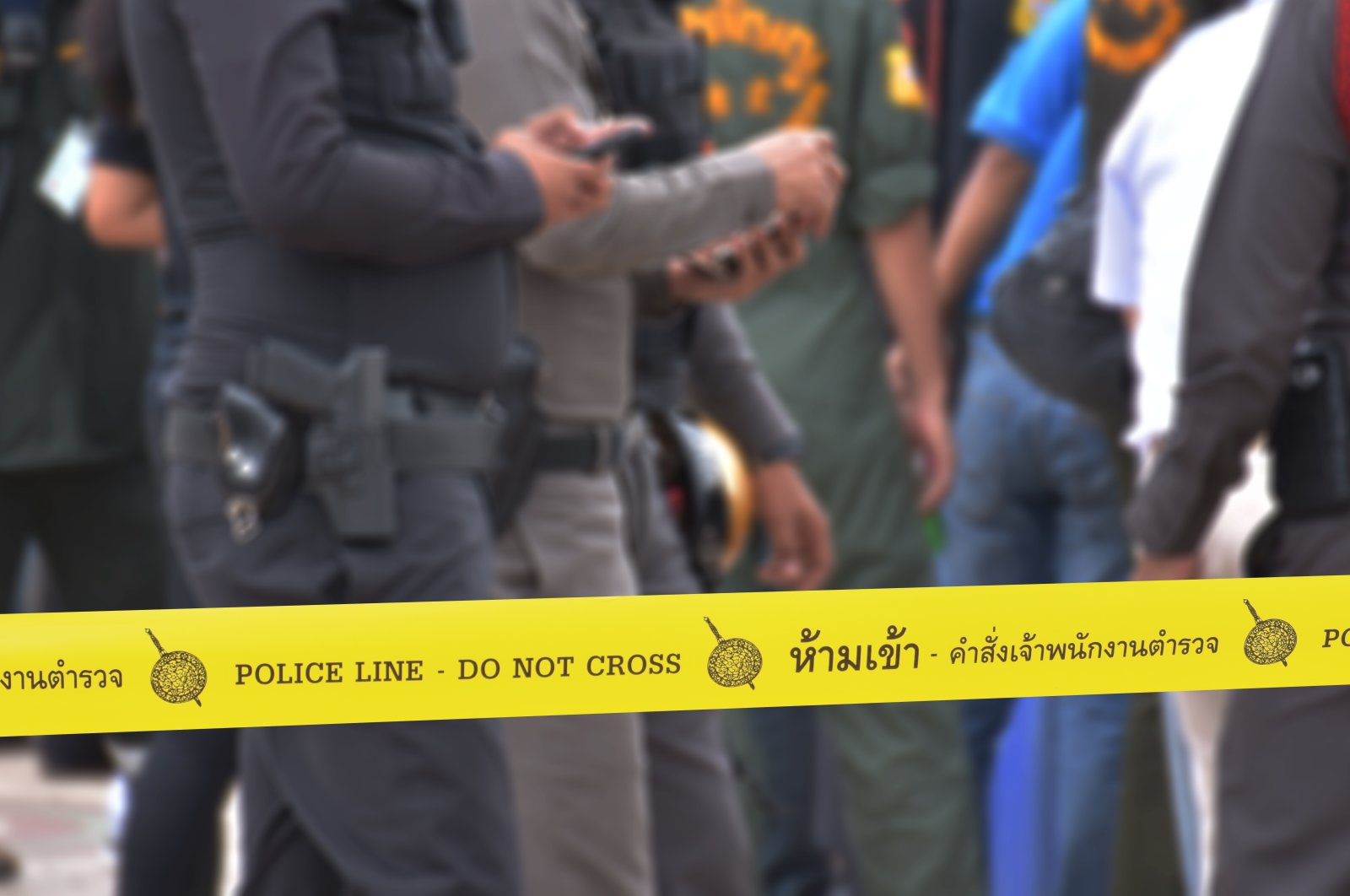 Yellow police tape says &quot;Police line do not cross,&quot; in Thai. (Shutterstock Photo)
