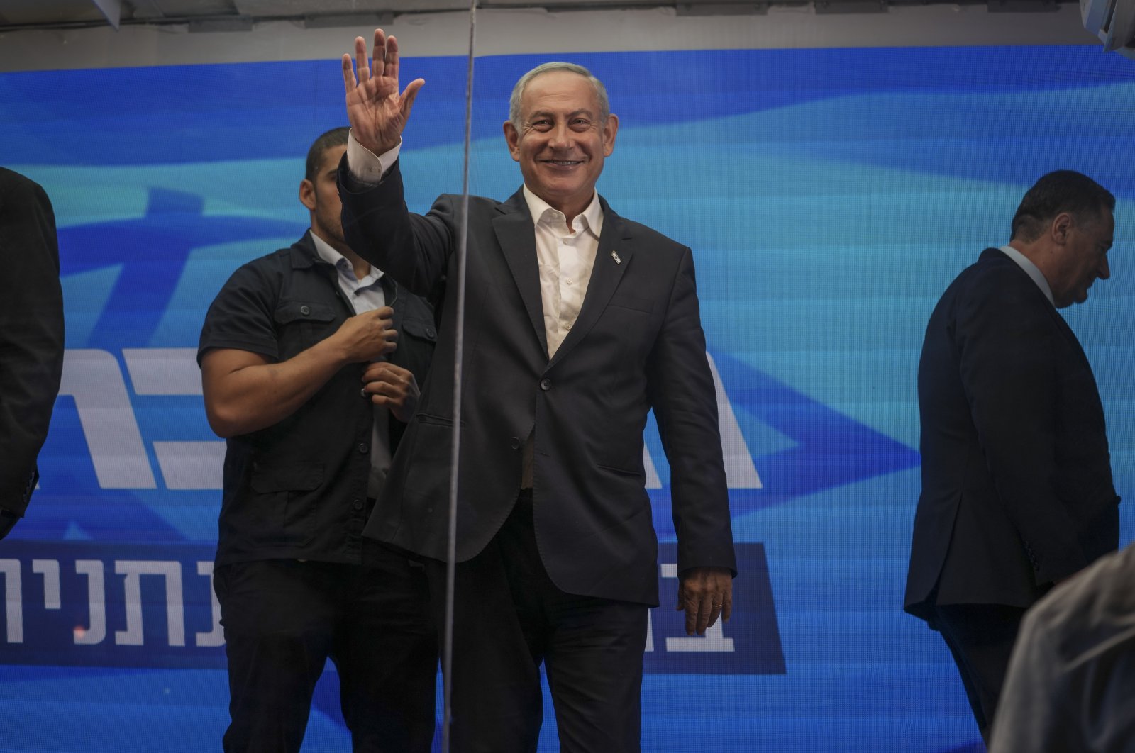 Former Israeli Prime Minister Benjamin Netanyahu waves after delivering an election campaign speech from inside a modified delivery truck with a side wall replaced with bulletproof glass. Beersheba, Israel, Sept. 13, 2022. (AP Photo)