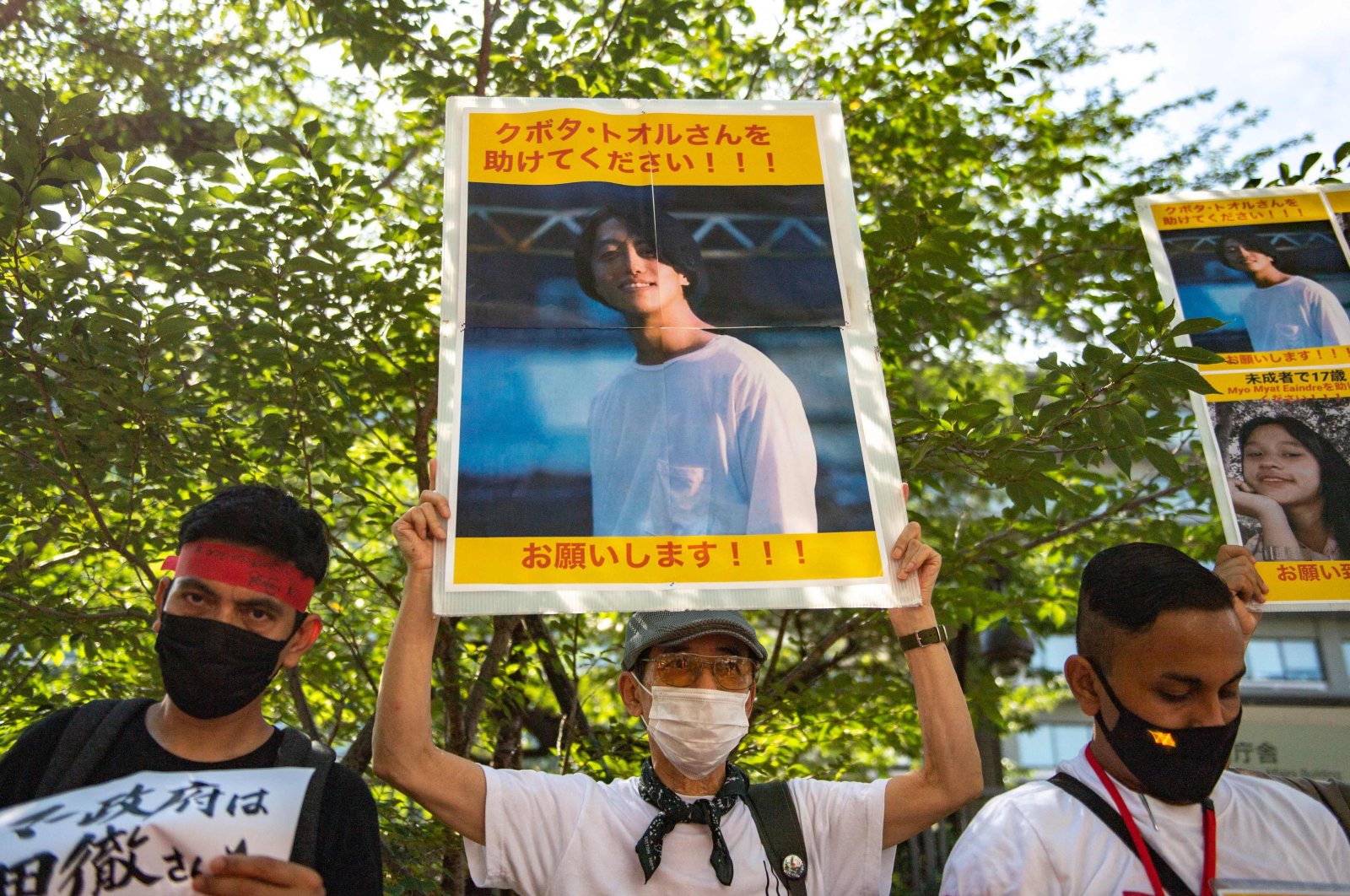 A group of activists holding up placards with images of Japanese citizen Toru Kubota, who was detained in Myanmar, during a rally in front of the Ministry of Foreign Affairs,Tokyo, Japan, July 31, 2022 (AFP Photo)