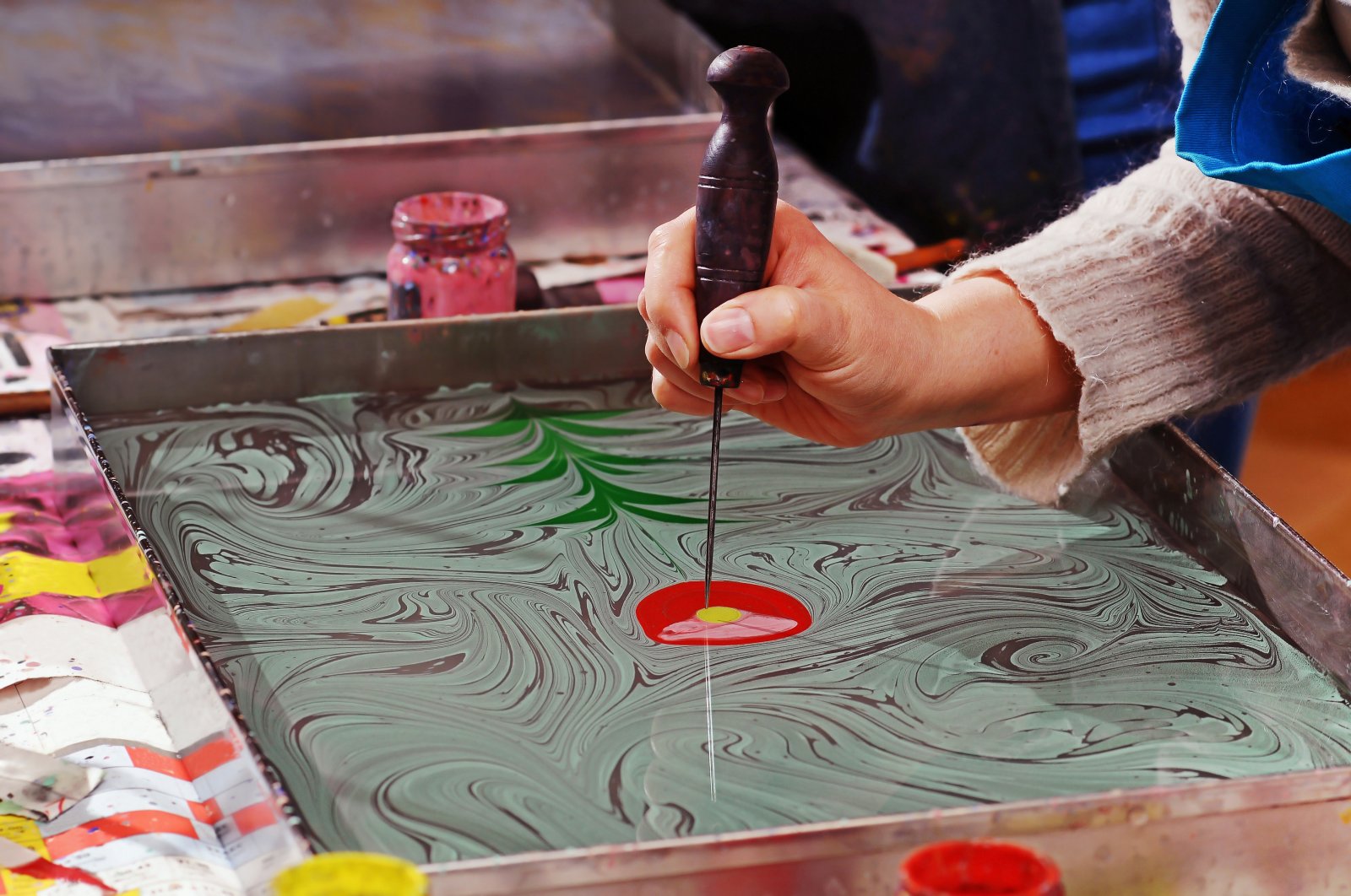 An artist practices the art of Turkish marbling, known as ebru. (Shutterstock Photo)