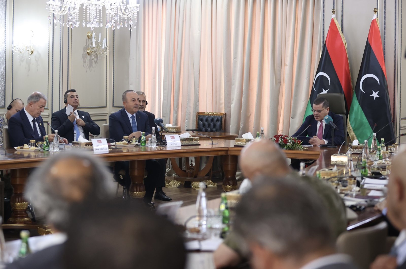 The leader of the Tripoli-based unity government and Prime Minister Abdul Hamid Mohammed Dbeibah (R) during a meeting with high-level Turkish delegation including Foreign Minister Mevlüt Çavuşoğlu (2nd L) and Defense Minister Hulusi Akar (L), in the capital Tripoli, Libya, Oct. 3, 2022. (AA Photo)