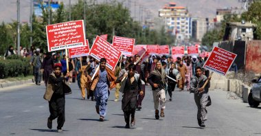 Afghans hold anti-U.S. placards during a protest against the U.S. move to transfer $3.5 billion in Afghan central bank assets to a new Swiss-based trust fund, in Kabul, Afghanistan, Sept.17, 2022. (EPA Photo) 