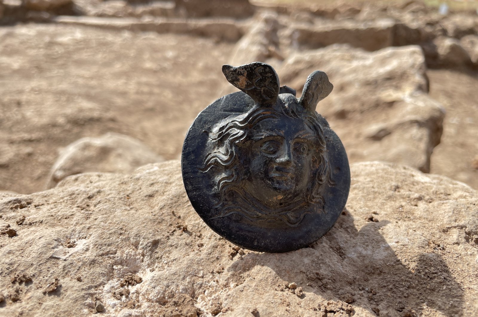 An 1,800-year-old military medal engraved with the head of Medusa in the ancient city of Perre, in Adıyaman, Türkiye, Oct. 5, 2022. (AA Photo)