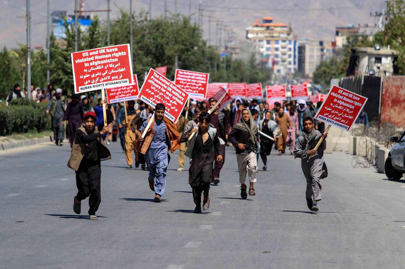 Afghans hold anti-U.S. placards during a protest against the U.S. move to transfer $3.5 billion in Afghan central bank assets to a new Swiss-based trust fund, in Kabul, Afghanistan, Sept.17, 2022. (EPA Photo) 