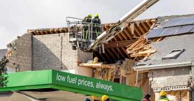 Emergency services inspect the scene following an explosion in Creeslough, northwest Ireland, Oct. 8, 2022. (AFP Photo)