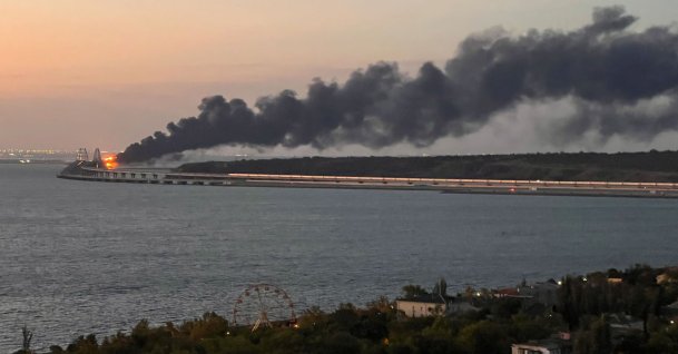 A view shows a fire on the Kerch bridge at sunrise in the Kerch Strait, Crimea, Oct. 8, 2022. (Reuters Photo)