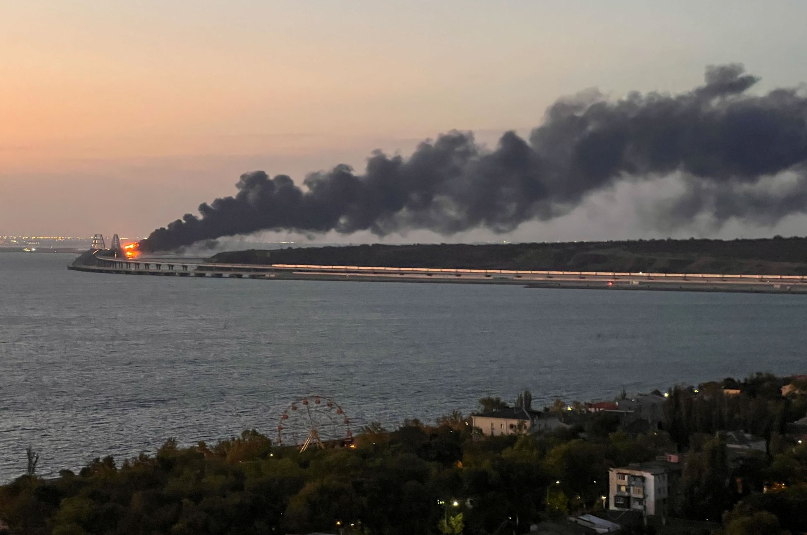 A view shows a fire on the Kerch bridge at sunrise in the Kerch Strait, Crimea, Oct. 8, 2022. (Reuters Photo)