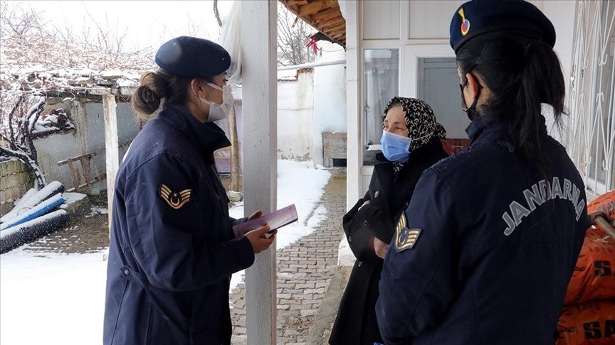 Gendarmerie officers inform a woman about services to protect women against domestic violence, Yozgat, central Türkiye, Mar. 7, 2022.