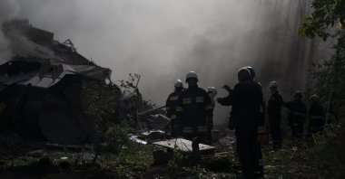 Firefighters work at the scene where a residential building was heavily damaged after a Russian attack in Zaporizhzhia, Ukraine, Oct. 9, 2022. (AP Photo)