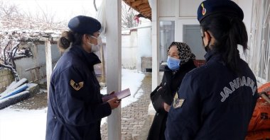 Gendarmerie officers inform a woman about services to protect women against domestic violence, Yozgat, central Türkiye, Mar. 7, 2022.