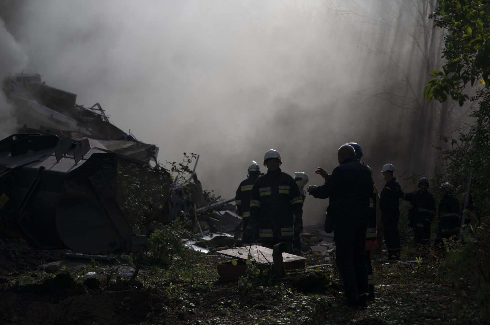 Firefighters work at the scene where a residential building was heavily damaged after a Russian attack in Zaporizhzhia, Ukraine, Oct. 9, 2022. (AP Photo)