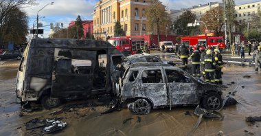 Rescue workers survey the scene of a Russian attack on Kyiv, Ukraine, Oct. 10, 2022. (AP Photo)