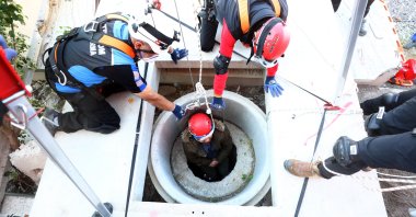 A search and rescue crew member lowered into a well during the drill, in the capital Ankara, Türkiye, Oct. 10, 2022. (AA Photo)