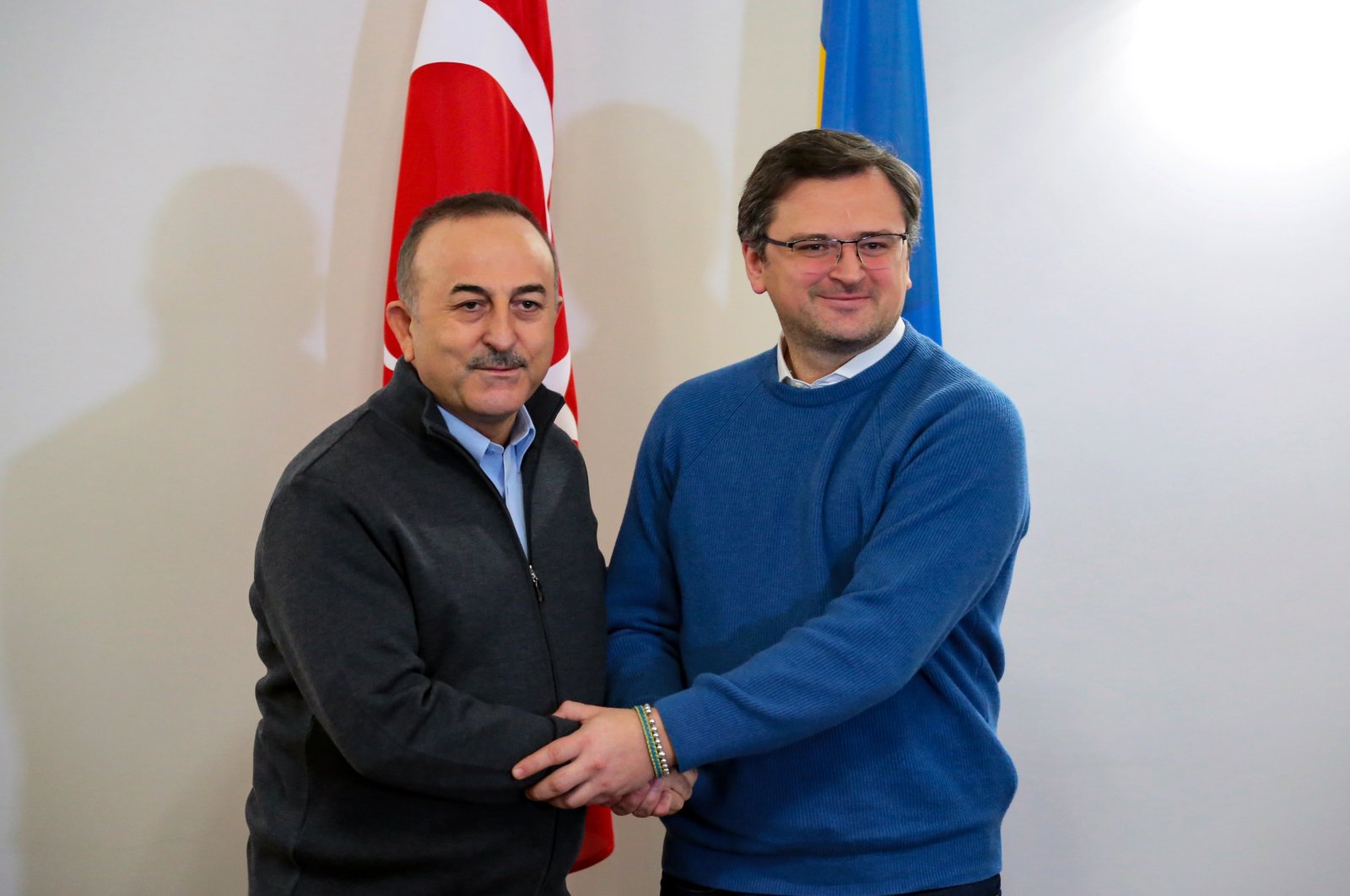 Foreign Minister Mevlüt Çavuşoğlu (L) and Ukrainian Foreign Minister Dmytro Kuleba shake hands during a meeting in Lviv, western Ukraine, March 17, 2022. (Reuters Photo)