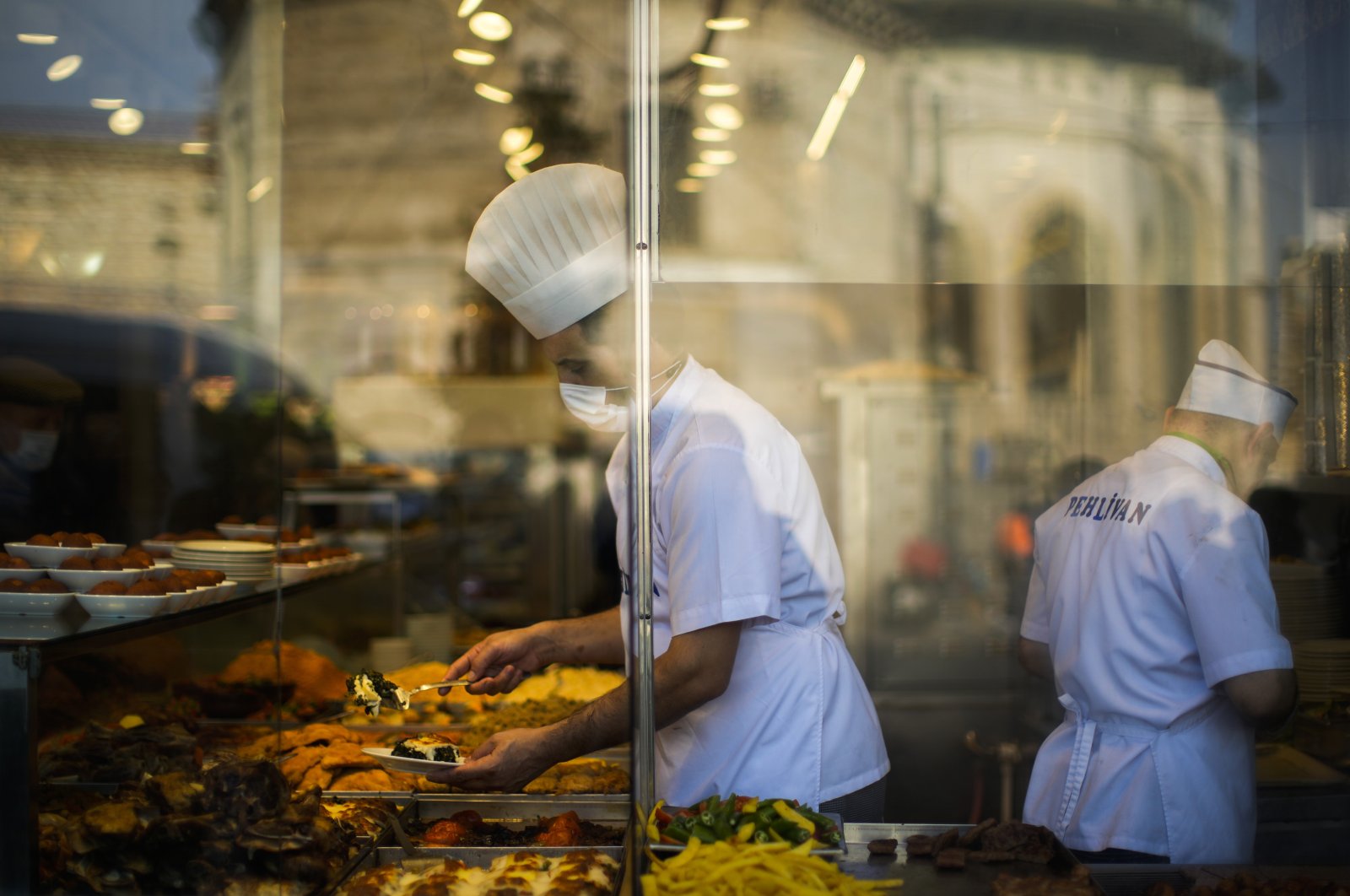 A chef serves meals to clients in a local restaurant in Istanbul, Türkiye, Jan. 3, 2022. (AP Photo)