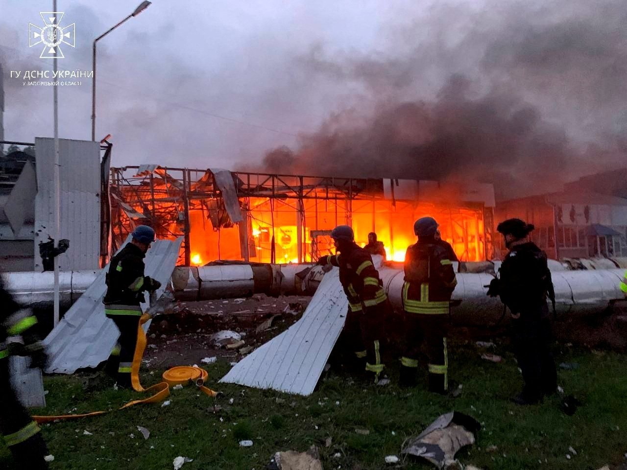 Firefighters work at the site of a car retailer office building, destroyed during a Russian missile attack, Zaporizhzhia, Ukraine, Oct. 11, 2022. (Reuters Photo)