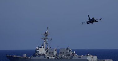 A Turkish F-16 fighting jet flies over naval ships during an annual NATO naval exercise on Turkey&#039;s western coast on the Mediterranean, Sept. 15, 2022. (AP Photo)