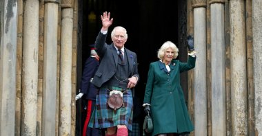 Britain's King Charles III (R) and Britain's Camilla, Queen Consort, wave as they walk to meet members of the public after leaving from Dunfermline Abbey in Dunfermline in southeast Scotland, U.K., Oct. 3, 2022. (AFP Photo)