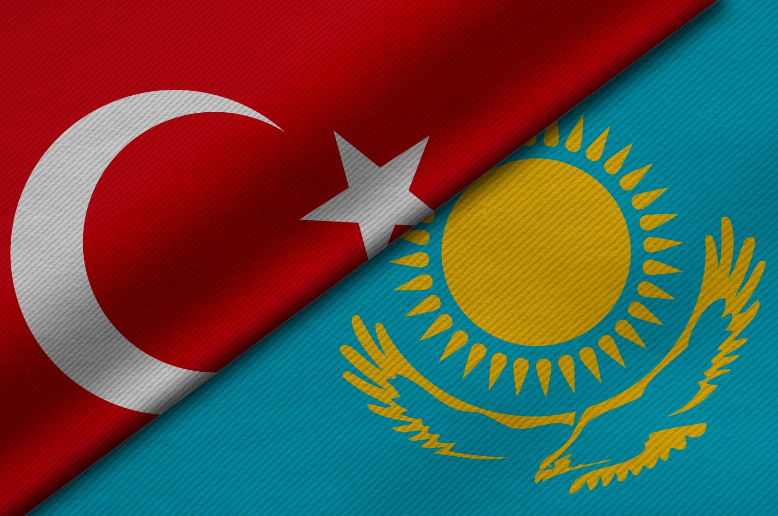 The flags of Türkiye and Kazakhstan are seen side by side in this illustration photo. (Shutterstock Photo)
