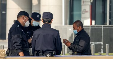 Security offiers check a man's identification before entering the vicinity of Tiananmen Square. Beijing, China, Oct. 12 2022. (EPA Photo)