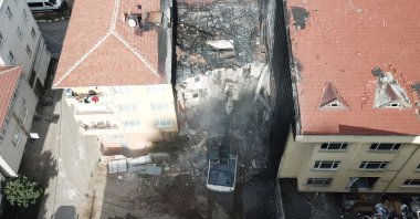 An aerial view of a bulldozer razing the building where the blast occurred, in Istanbul, Türkiye, Oct. 12, 2022. (DHA Photo)