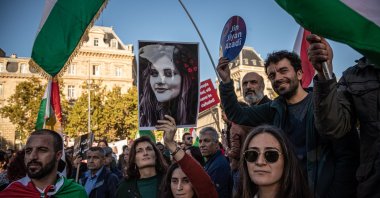 A woman holds a portrait of Mahsa Amini as people participate in a rally in support of Iranian women. Paris, France, Oct. 9, 2022. (EPA Photo)