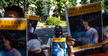 A group of activists hold placards of Japanese journalist Toru Kubota, who is detained in Myanmar, during a rally in front of the Ministry of Foreign Affairs, Tokyo, Japan, July 31, 2022. (AFP Photo)