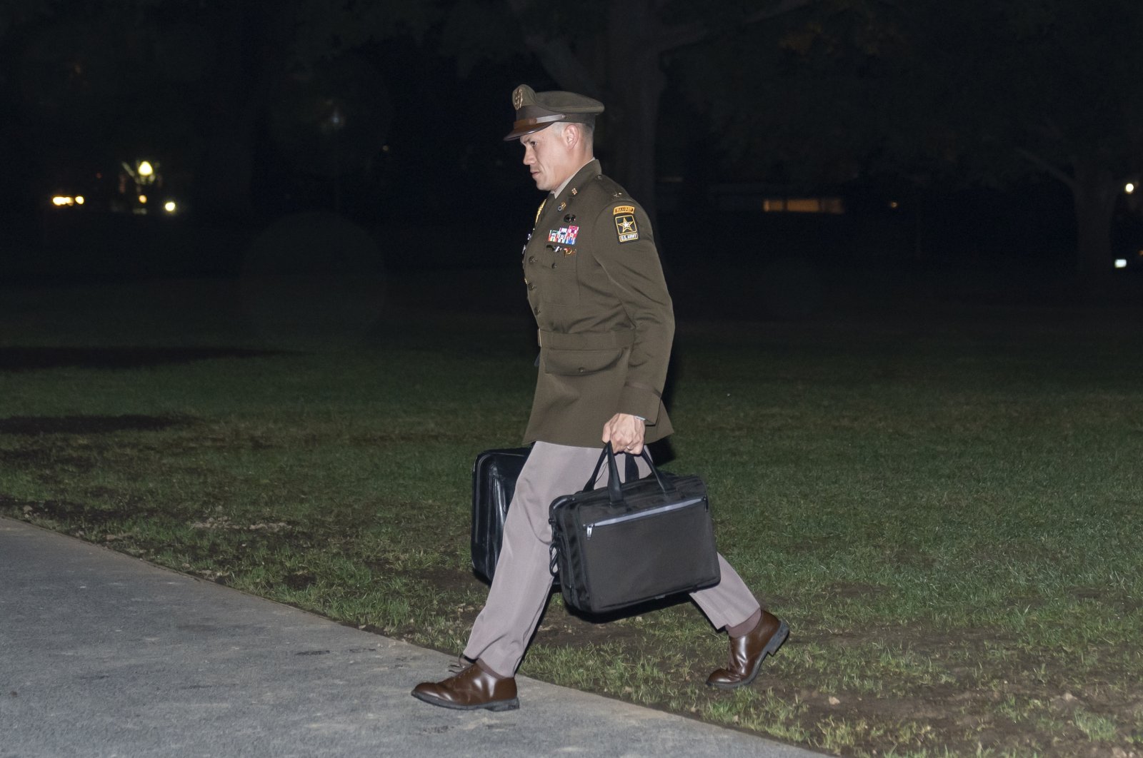 A U.S. Army officer military aide carries the nuclear launch codes known as the &quot;football,&quot; as he follows President Joe Biden into the White House after arriving on Marine One, Washington, U.S., Oct. 6, 2022. (AP Photo)