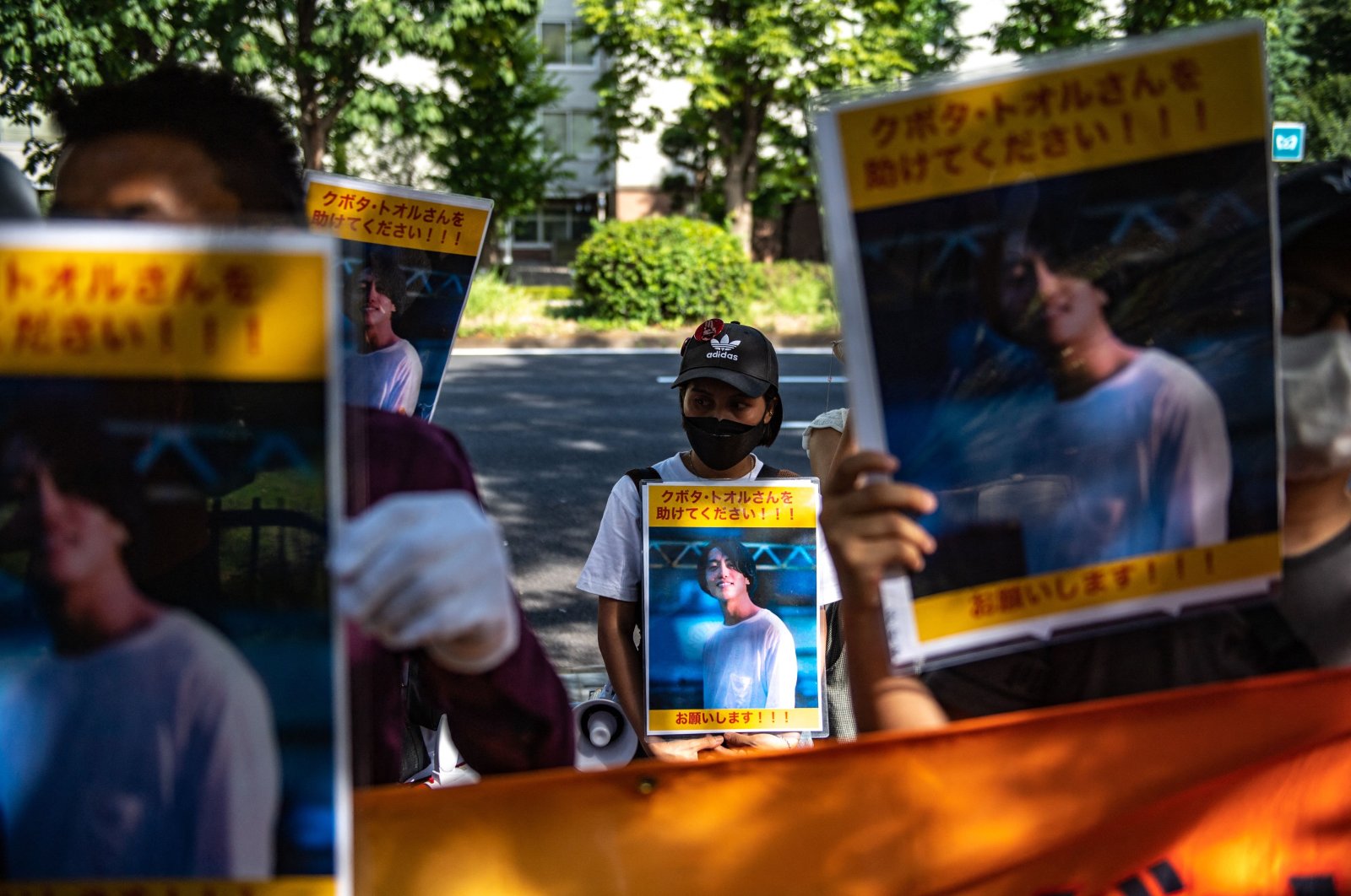 A group of activists hold placards of Japanese journalist Toru Kubota, who is detained in Myanmar, during a rally in front of the Ministry of Foreign Affairs, Tokyo, Japan, July 31, 2022. (AFP Photo)