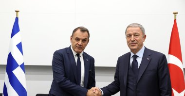Defense Minister Hulusi Akar and Greek counterpart Nikolaos Panagiotopoulos shake hands after a meeting in Brussels, Belgium, Oct. 13, 2022. (AA Photo)