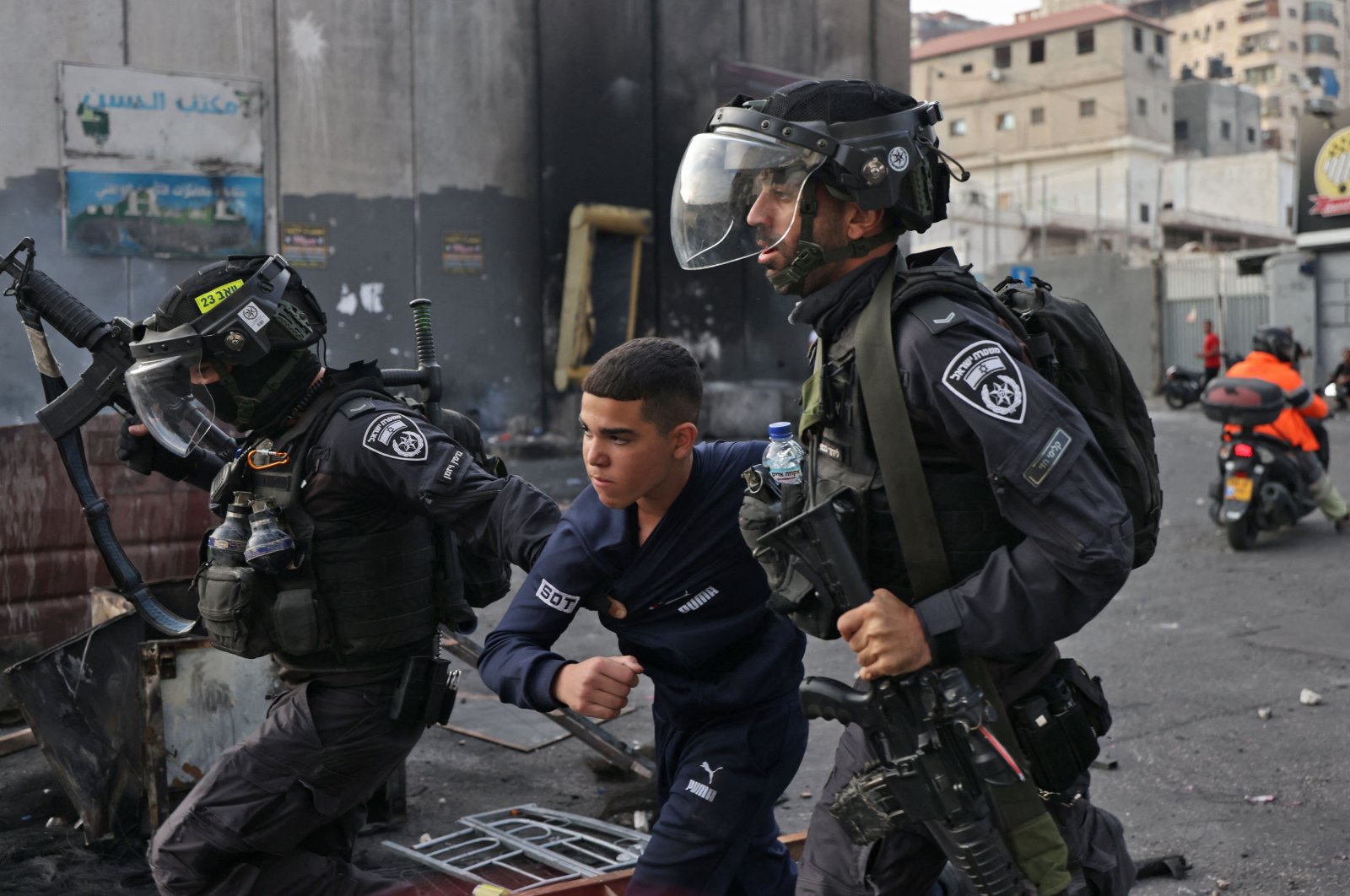 Members of the Israeli security forces arrest a young Palestinian protester during confrontations in the Shuafat refugee camp. Jerusalem, Israel, Oct. 12, 2022. (AFP Photo)