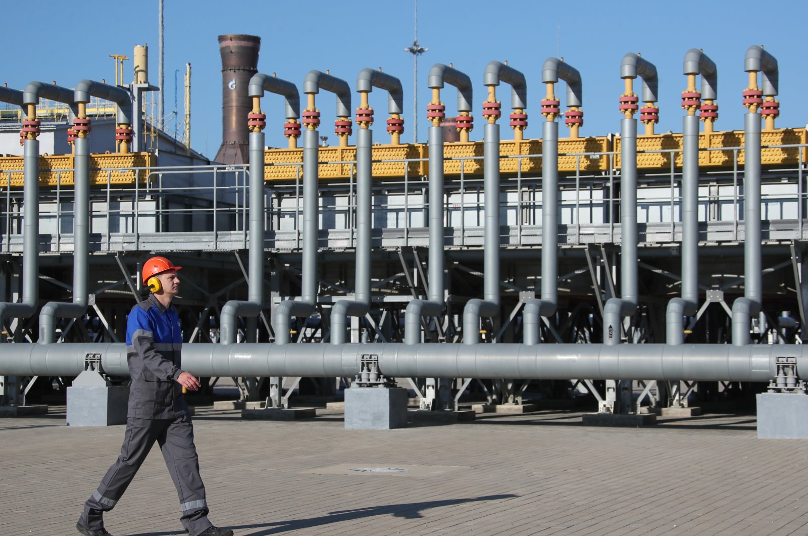 A worker walks by an air gas cooling unit at the Russkaya Compressor Station of the TurkStream gas pipeline, Anapa district, Krasnodar, southern Russia, Oct. 22, 2021. (Reuters Photo)