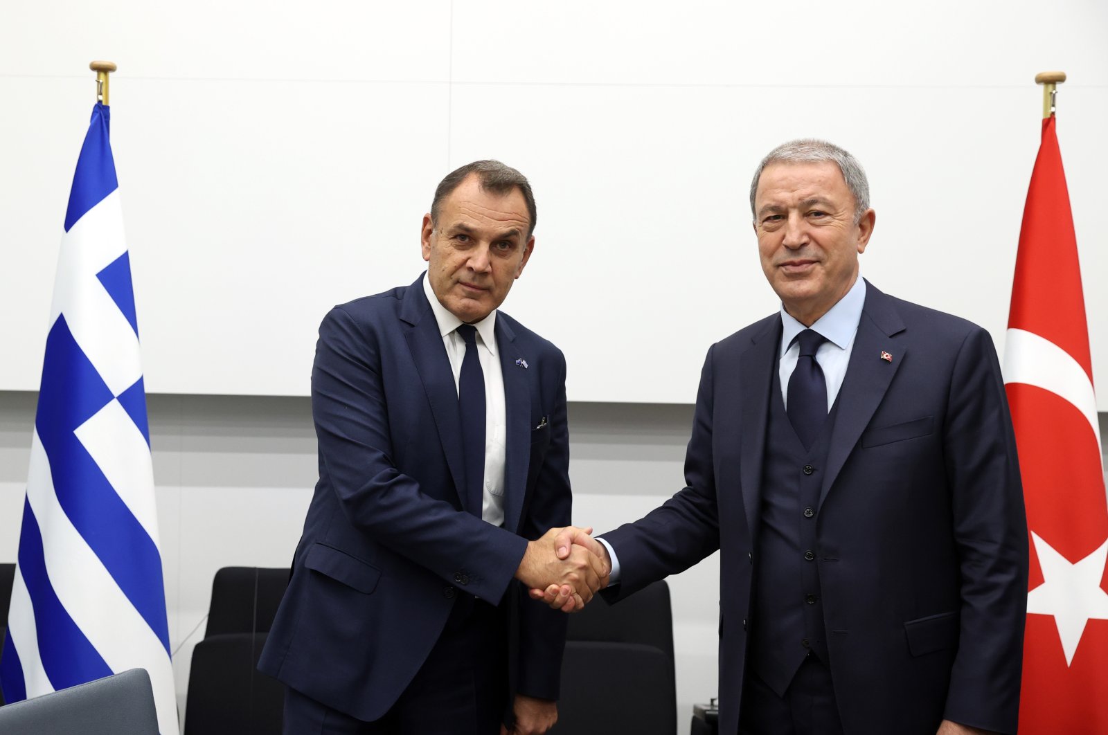 Defense Minister Hulusi Akar and Greek counterpart Nikolaos Panagiotopoulos shake hands after a meeting in Brussels, Belgium, Oct. 13, 2022. (AA Photo)
