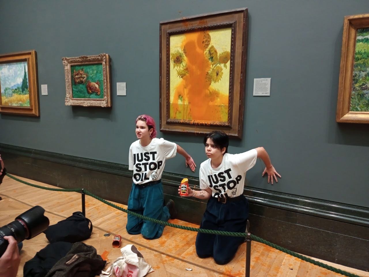 Climate activism group of two protesters who threw Heinz Tomato soup at Vincent Van Gogh&#039;s 1888 painting &quot;Sunflowers&quot; at the National Gallery in London, U.K., Oct. 14, 2022. (Just Stop Oil handout photo via EPA)