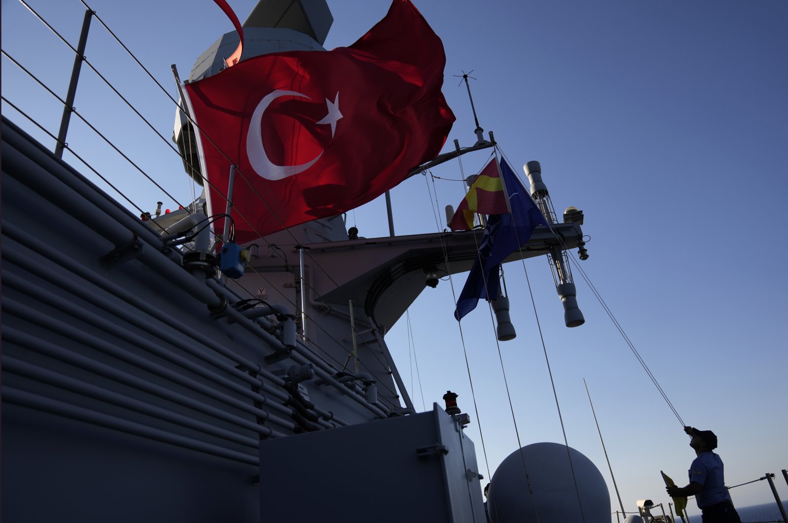 A naval officer checks the Turkish flag over a ship during an annual NATO naval exercise on Türkiye&#039;s western coast on the Mediterranean, Sept. 15, 2022. (AP Photo)
