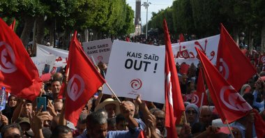 Supporters of the Tunisian Free Destourian Party wave national flags and raise placards during a demonstration against President Kais Saied in the capital Tunis, Tunisia, Oct. 15, 2022. (AFP Photo)