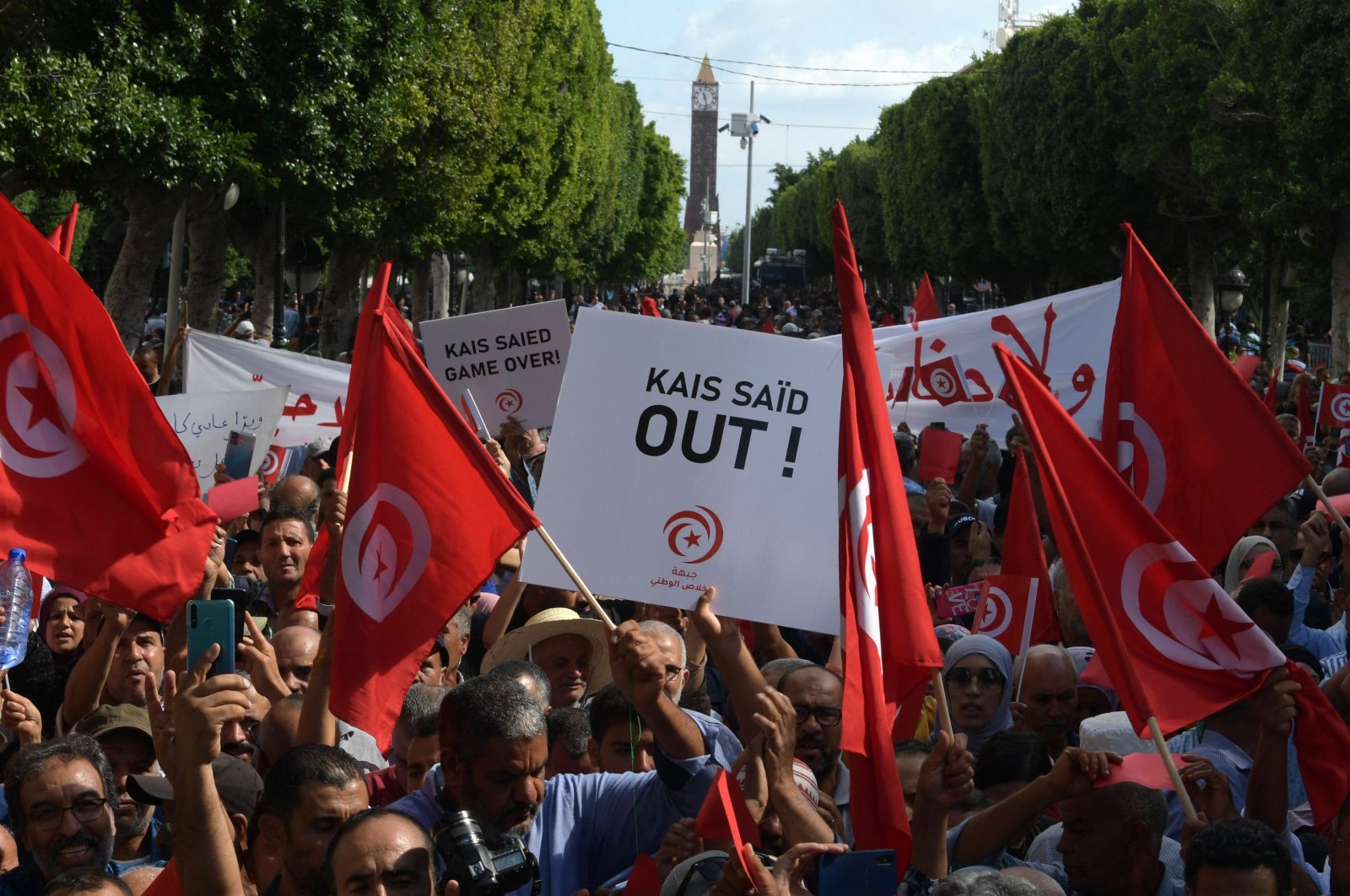Supporters of the Tunisian Free Destourian Party wave national flags and raise placards during a demonstration against President Kais Saied in the capital Tunis, Tunisia, Oct. 15, 2022. (AFP Photo)