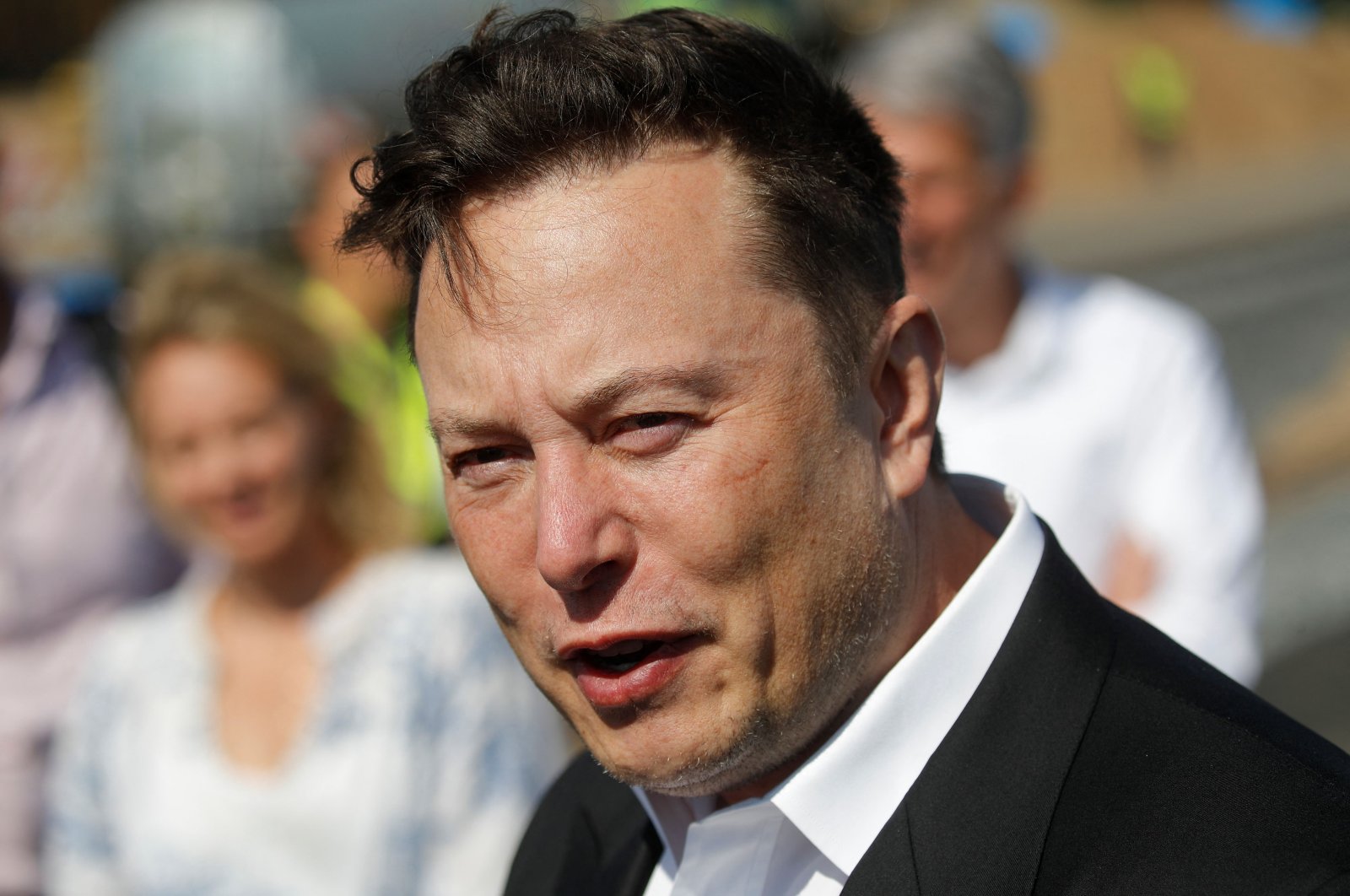 Tesla CEO Elon Musk talks to media as he arrives to visit the construction site of the future U.S. electric car giant Tesla, in Gruenheide near Berlin, Germany, Sept. 3, 2020. (AFP Photo)