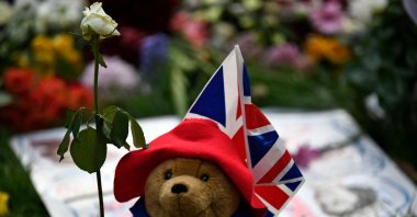 A Paddington Bear teddy bear is pictured with floral tributes in Green Park, near Buckingham Palace, London, U.K., Sept. 11, 2022. (AFP Photo)