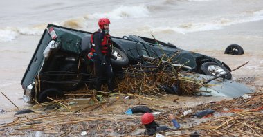 Rescuers search the waters along the beach of the popular resort of Agia Pelagia, on the southern Greek island of Crete, following flash floods on Oct.15, 2022. (AFP Photo)