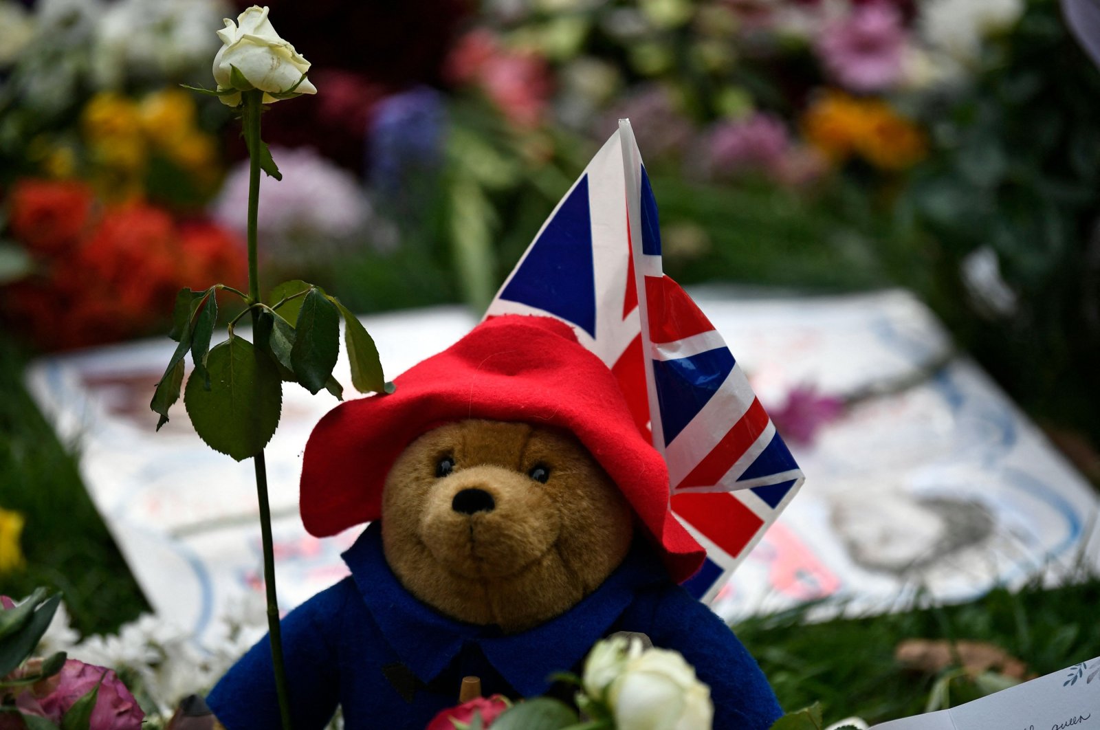A Paddington Bear teddy bear is pictured with floral tributes in Green Park, near Buckingham Palace, London, U.K., Sept. 11, 2022. (AFP Photo)