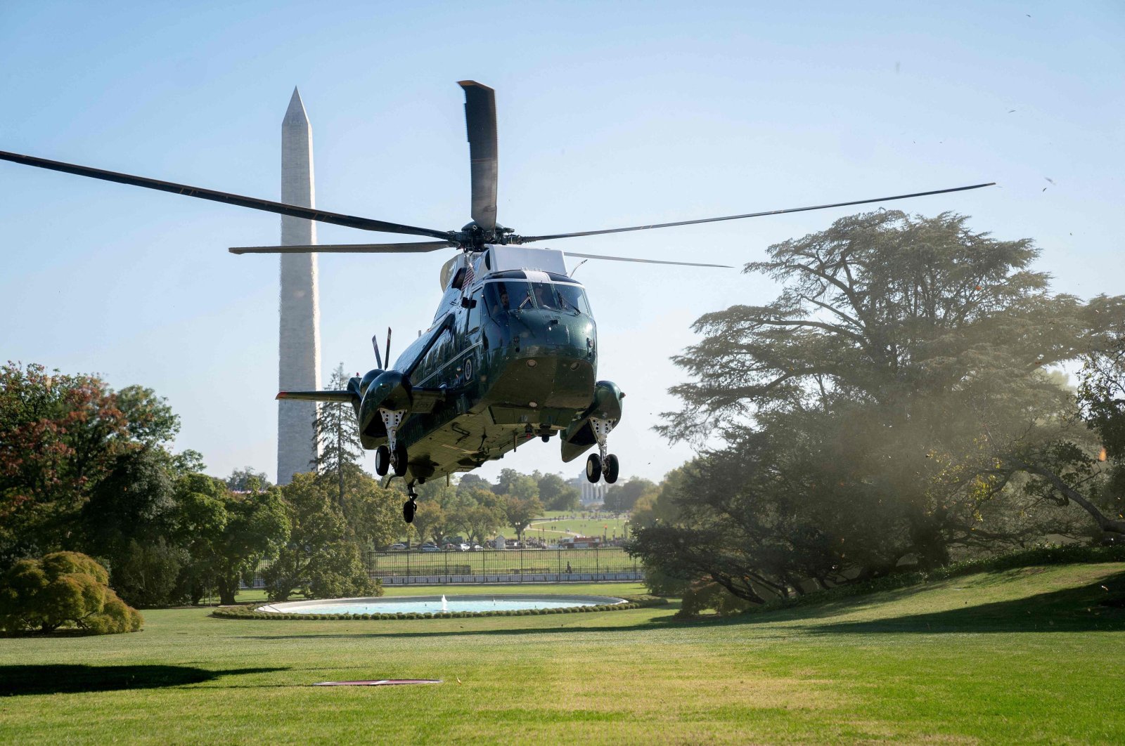 Pollen from a tree is swept through the air as Marine One, with U.S. President Biden on board, approaches the South Lawn of the White House, Washington, D.C., U.S., Oct. 10, 2022. (AFP Photo)