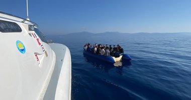 A Turkish coast guard boat approaches a migrant boat, in Izmir, western Türkiye, Sept. 6, 2022. (AA Photo)
