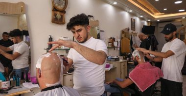 Palestinian men shave their hair at a salon, Hebron, West Bank, Palestine, Oct.16, 2022. (AFP Photo)