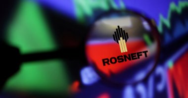 Rosneft logo and stock graph are seen through magnifier displayed in this illustration taken Sept. 4, 2022. (Reuters Photo)