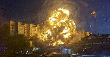 In this handout photo released by Kooperativ Telegram Channel, flames and smoke rise from the scene after a warplane crashed into a residential area in Yeysk, Russia, Monday, Oct. 17, 2022.  (Kooperativ Telegram Channel via AP)