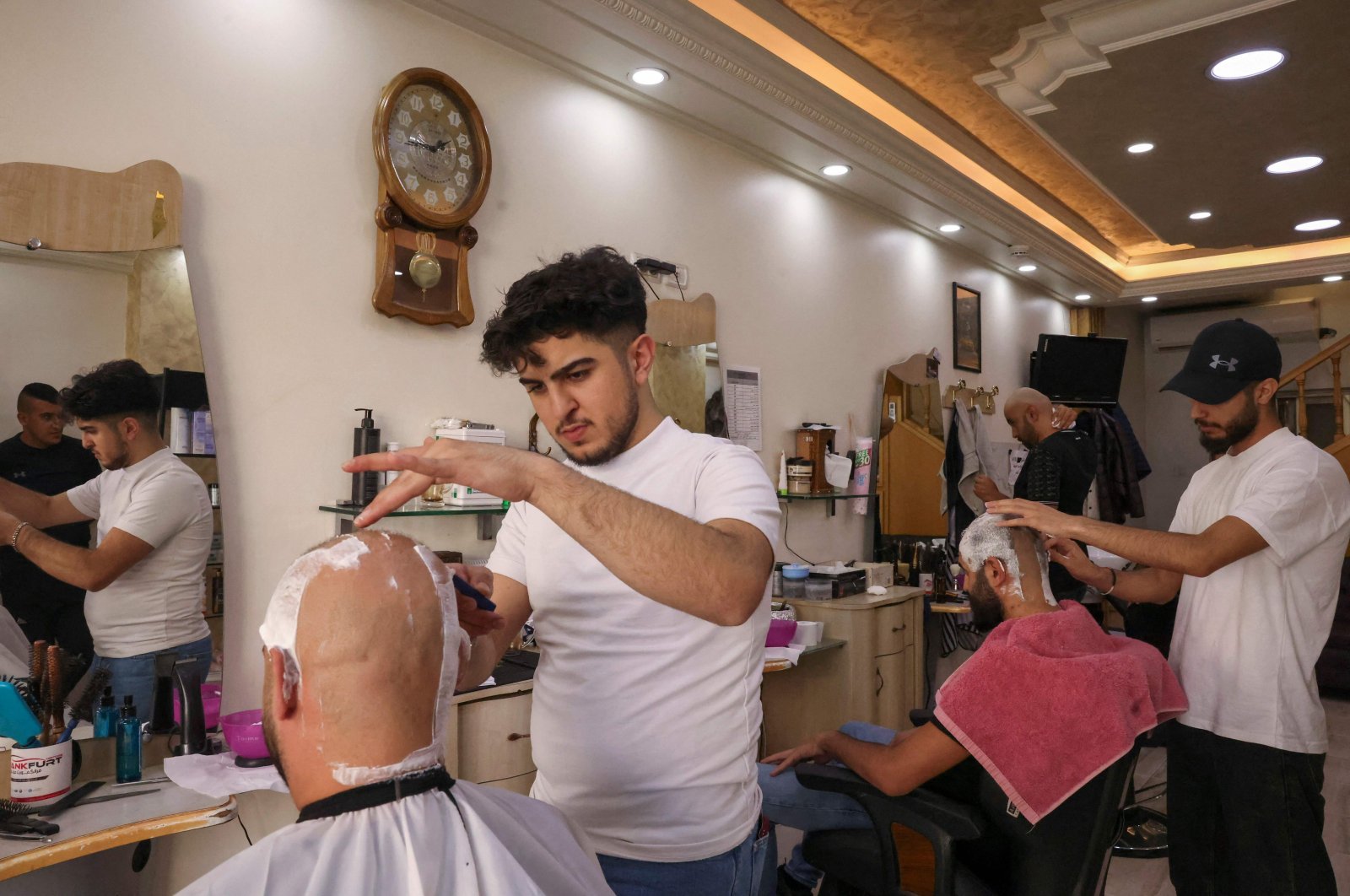 Palestinian men shave their hair at a salon, Hebron, West Bank, Palestine, Oct.16, 2022. (AFP Photo)
