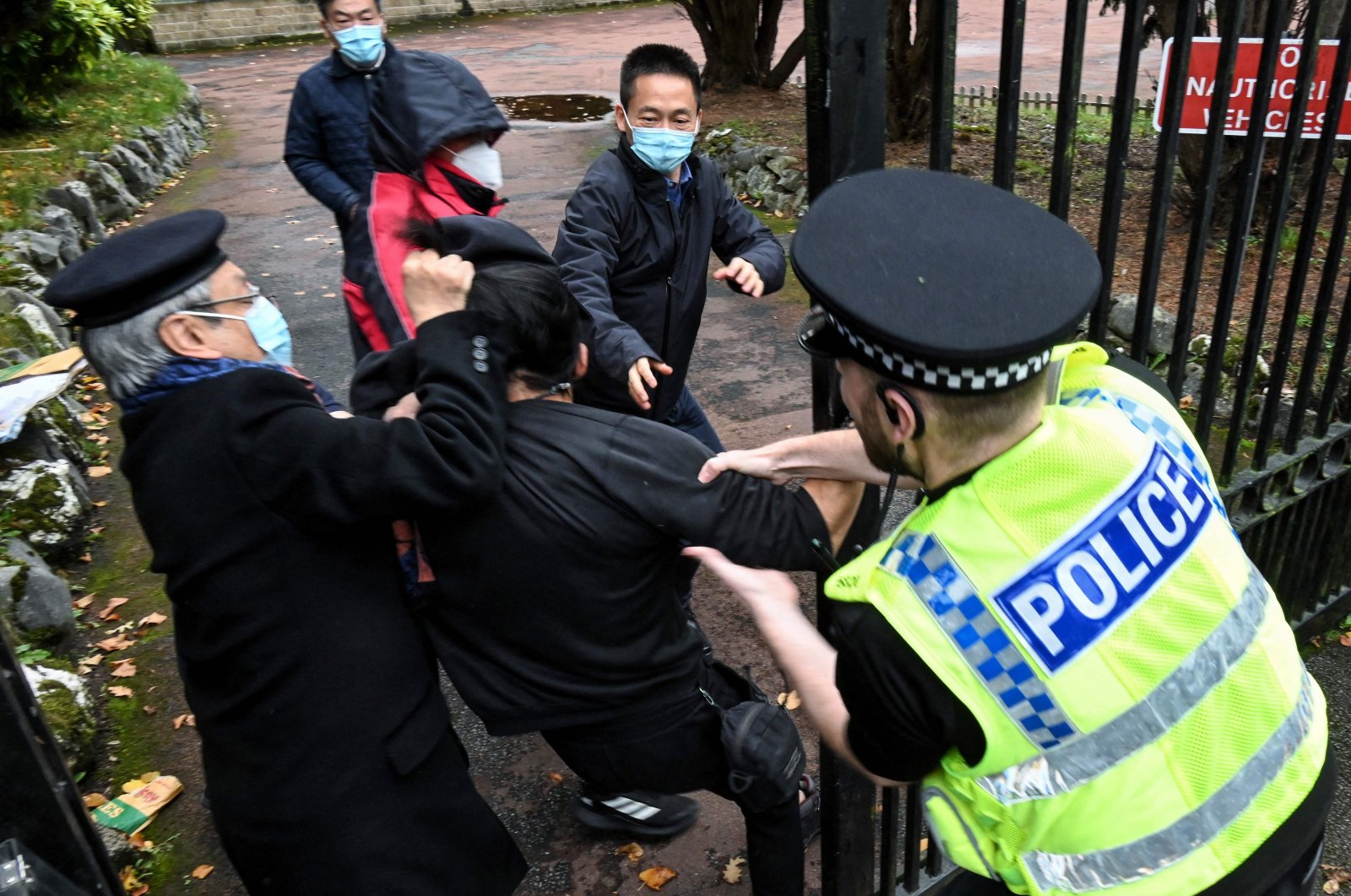 A scuffle between a Hong Kong pro-democracy protester (C) and Chinese Consulate staff, as a British police officer attempts to intervene, during a demonstration outside the consulate, Manchester, Britain, Oct. 17. (AFP Photo)